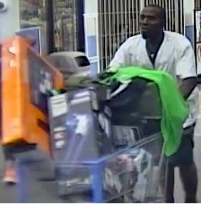 Photo of the suspect pushing a cart filled with items.